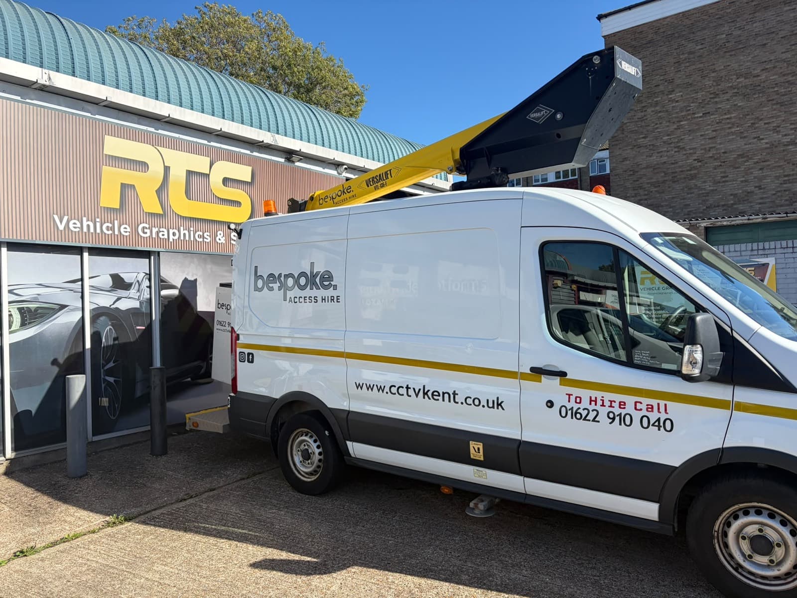 The Bespoke Access Hire van parked beside a unit, its Versalift boom and basket stowed above the cab