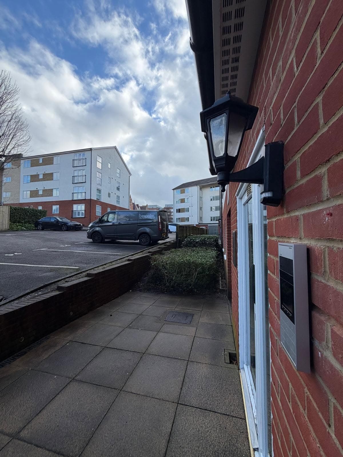 Door entry panel installed on an apartment block exterior with the Bespoke van in the car park