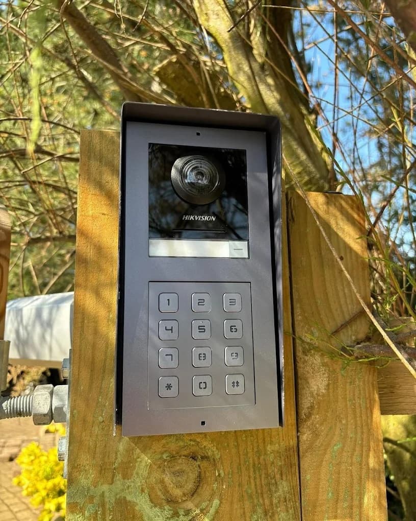 HIKVISION video door entry keypad at a gate post