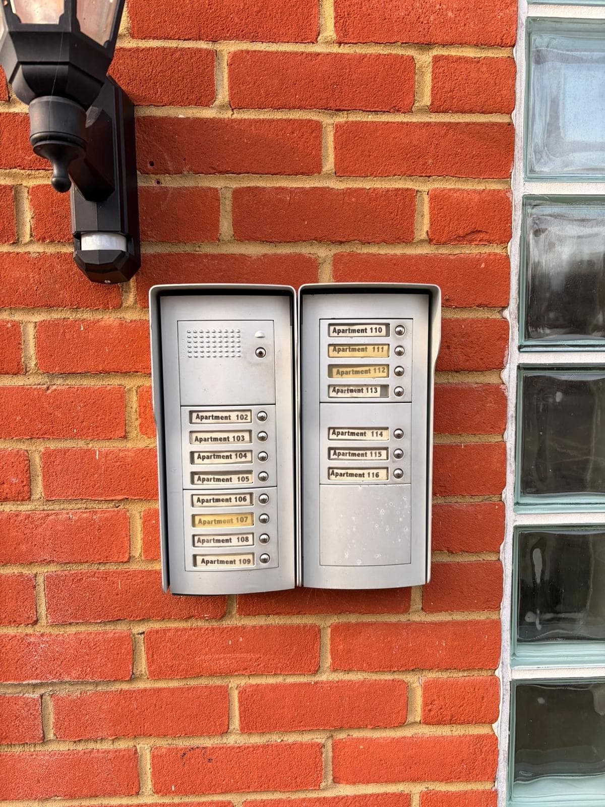 Apartment door entry panels installed on a brick wall