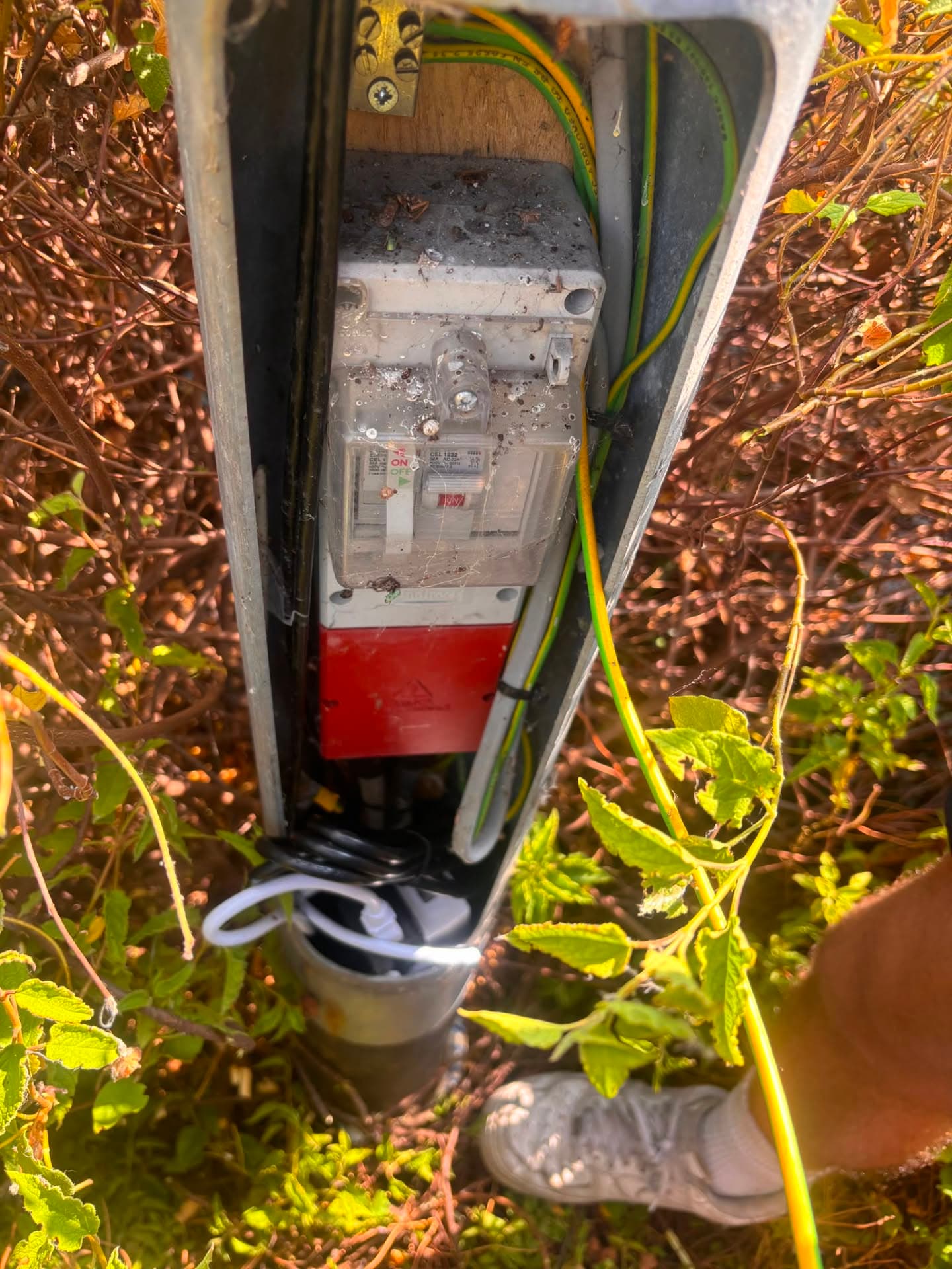 Weatherproof RCD isolator and motor capacitor in an outdoor gate power supply pillar