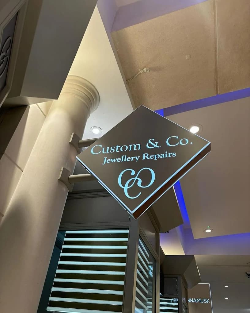 Illuminated shop sign installation at height