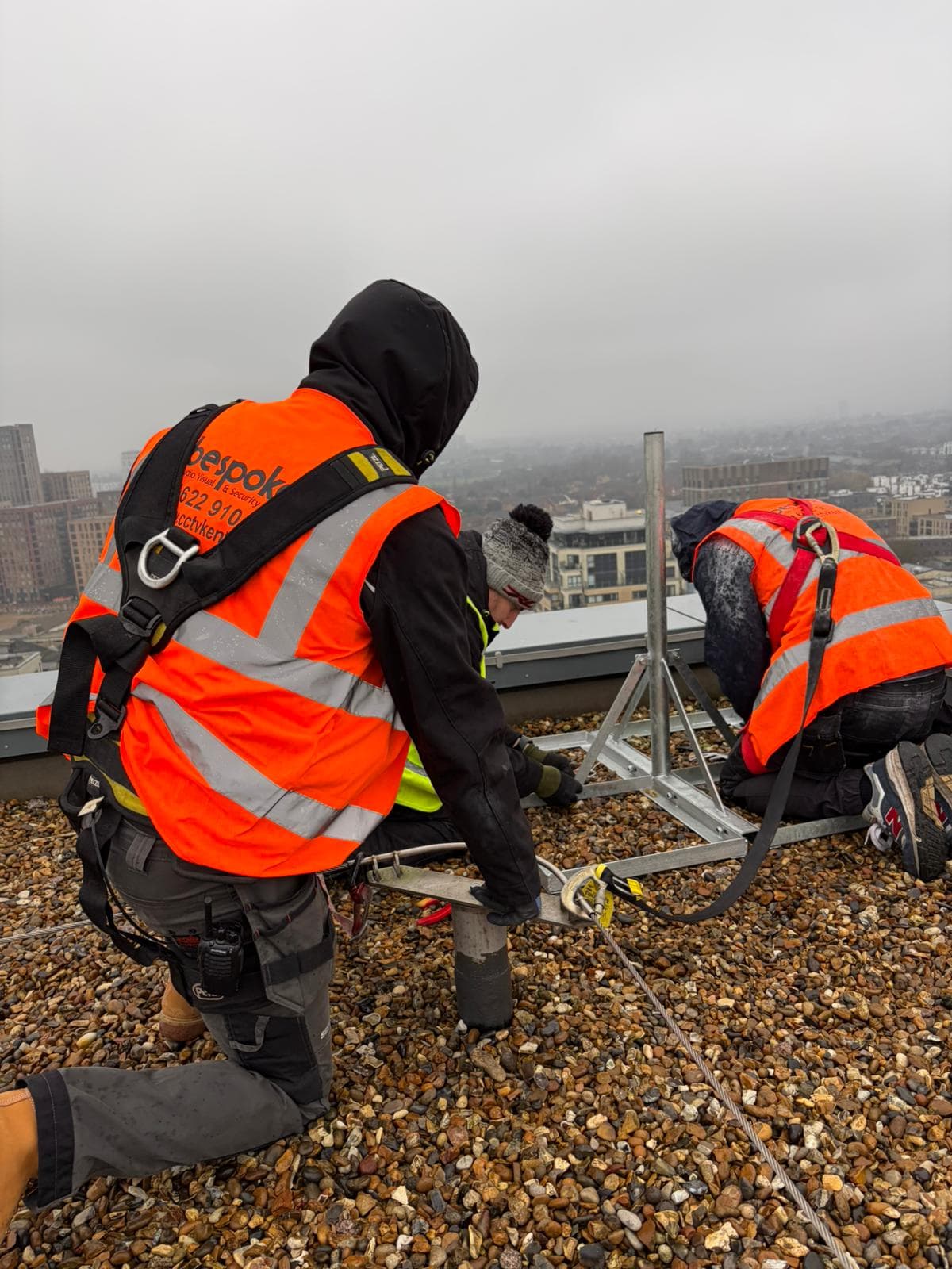 Bespoke AVS engineers installing an aerial mast on a London rooftop